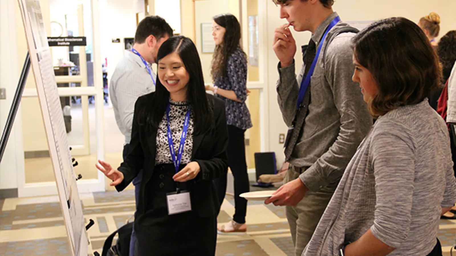 Photo of student presenting poster